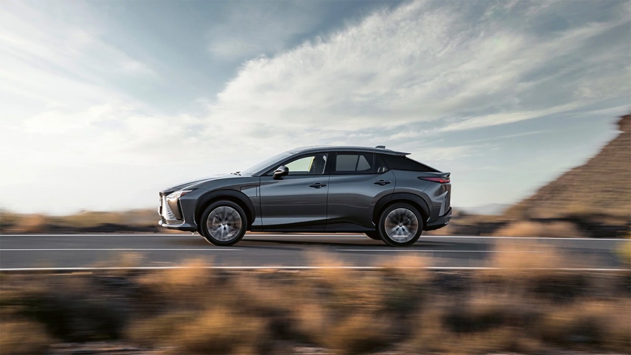 A Lexus UX 300e plugged into a charging tower