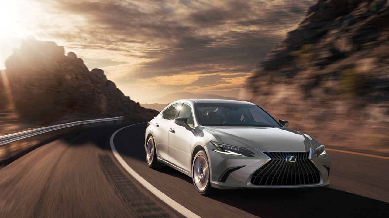 A black Lexus ES 300h driving on a road