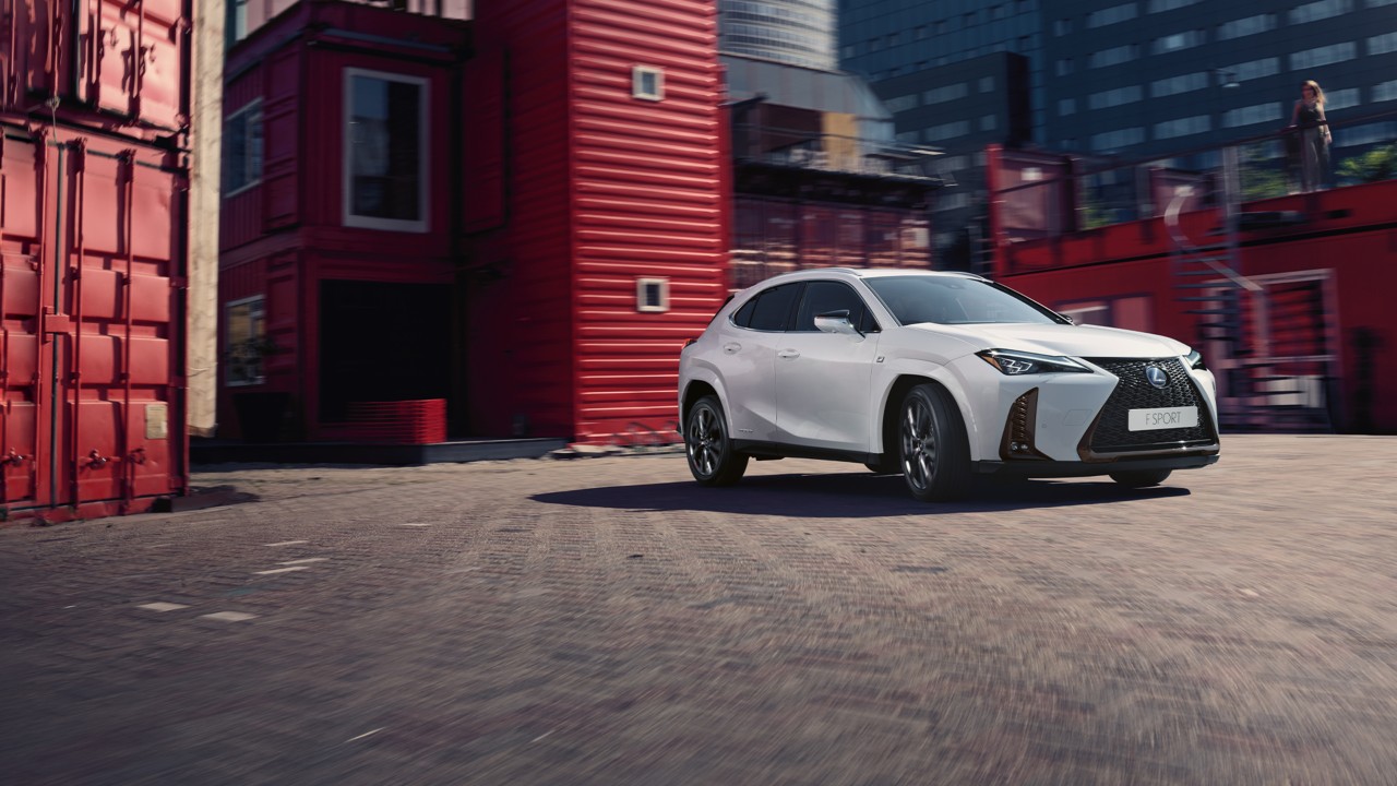 Lexus UX parked in front of shipping containers 