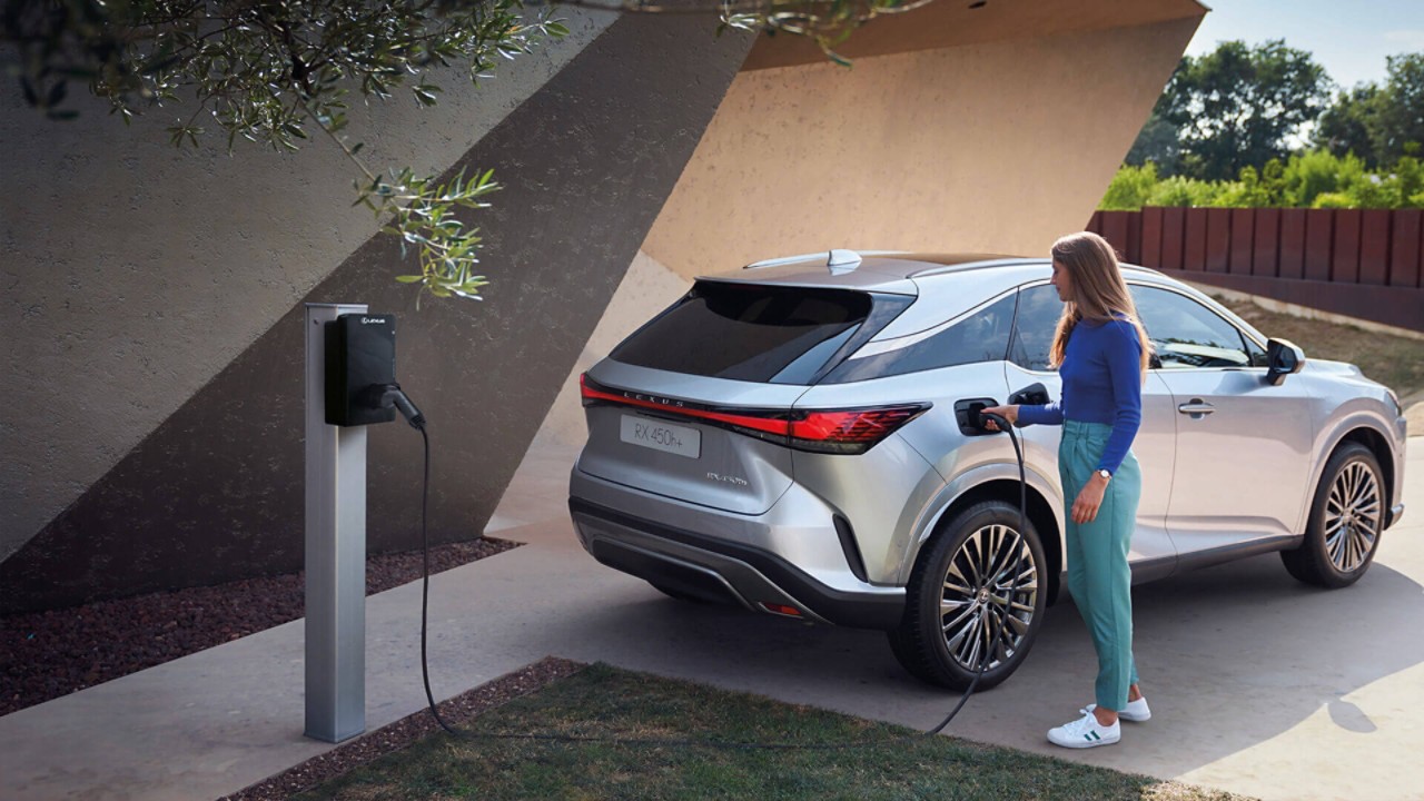 A Lexus RZ 450e plugged into a charging box